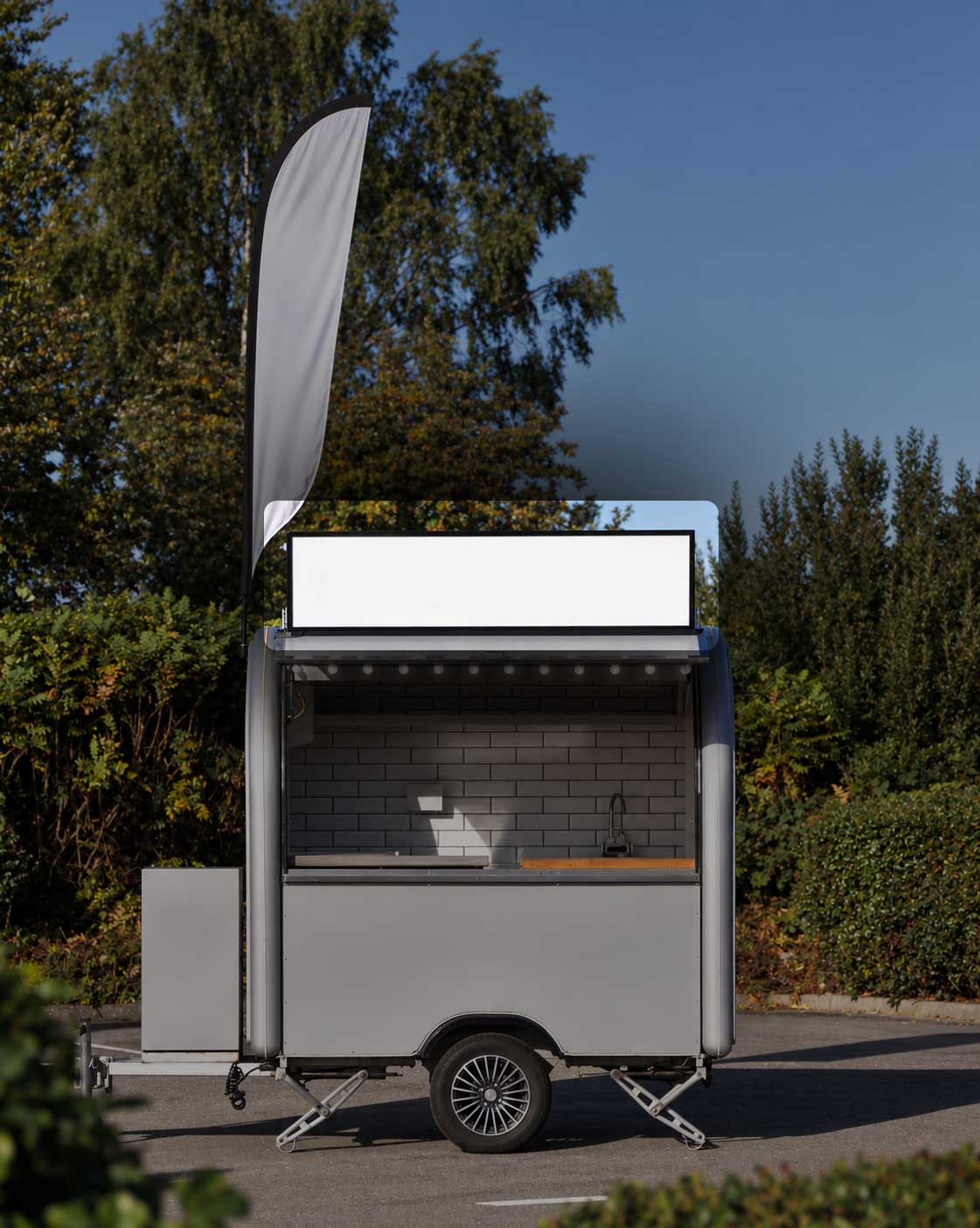 Mr Hot Dog food truck with an illuminated branded header sign